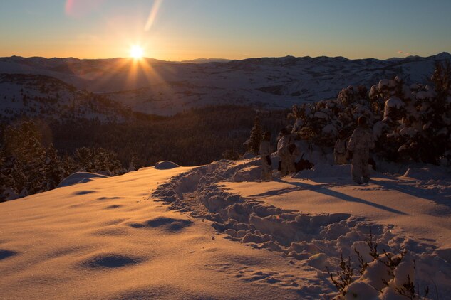 Marines from Golf Company, 2nd Battalion, 2nd Marine Regiment, 2nd Marine Division watch the sun set from their patrol base atop a mountain during the final six-day field exercise for Mountain Exercise winter training package at MCMWTC Bridgeport, Calif., Feb. 3, 2014. The Warlords and its attached units underwent the winter training package at MCMWTC to prepare for the upcoming a multi-lateral joint and combined exercise Cold Response, which will take place in March of 2014 in Norway.