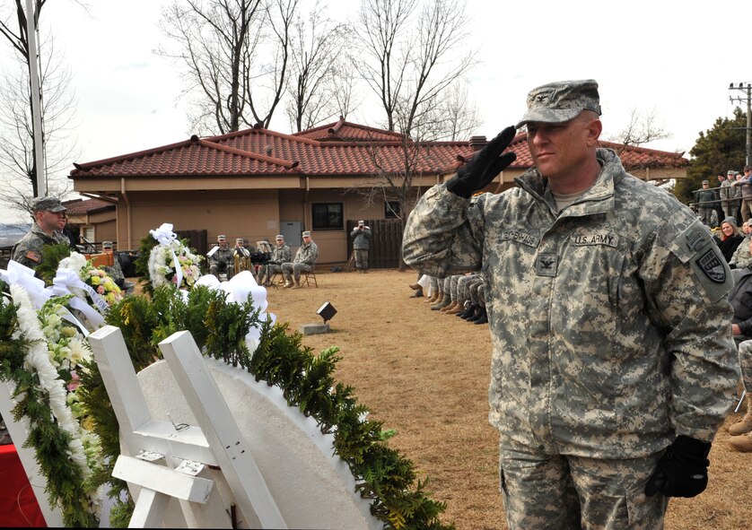 U.S. Col. Joseph Gleichenhaus, 3rd Battlefield Coordination Detachment-Korea commander, salutes a wreath honoring those who fought and those who gave their lives in the Battle of Bayonet Hill during the Hill 180 remembrance ceremony at Osan Air Base, Republic of Korea, Feb. 7, 2014. Base personnel thronged the area near the battle’s monument to witness the annual ceremony and subsequent laying of the wreaths. (U.S. Air Force photo/Airman 1st Class Ashley J. Thum)
