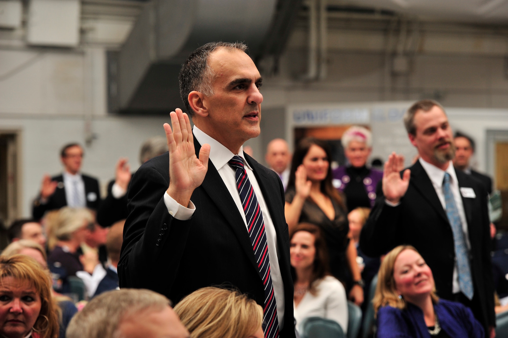 Michael Tatoian, executive vice president and chief operations officer for Dover Motorsports, Inc., recites the honorary commander oath, Feb. 8, 2013, at Dover Air Force Base, Del. Tatoian was one of 34 civic leaders inducted into the Dover AFB honorary commander program during a ceremony held at the Air Mobility Command Museum. (U.S. Air Force photo/Staff Sgt. Elizabeth Morris)