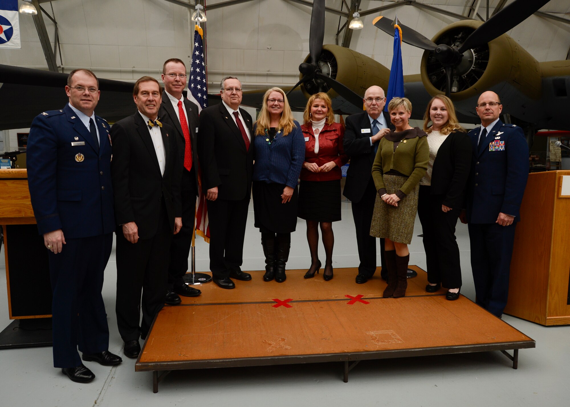 Col. Rick Moore, commander of the 436th Airlift Wing (left) and Col. Raymond Kozak, commander of the 512th Airlift Wing (right), pose with outgoing 2013 Honorary Commanders during the 2014 Honorary Commander Induction Ceremony Feb. 8, 2014, at the Air Mobility Command Museum, Dover Air Force Base, Del. The 2013 Honorary Commanders were inducted as honorary commander alumni. (U.S. Air Force photo/Staff Sgt. Elizabeth Morris)