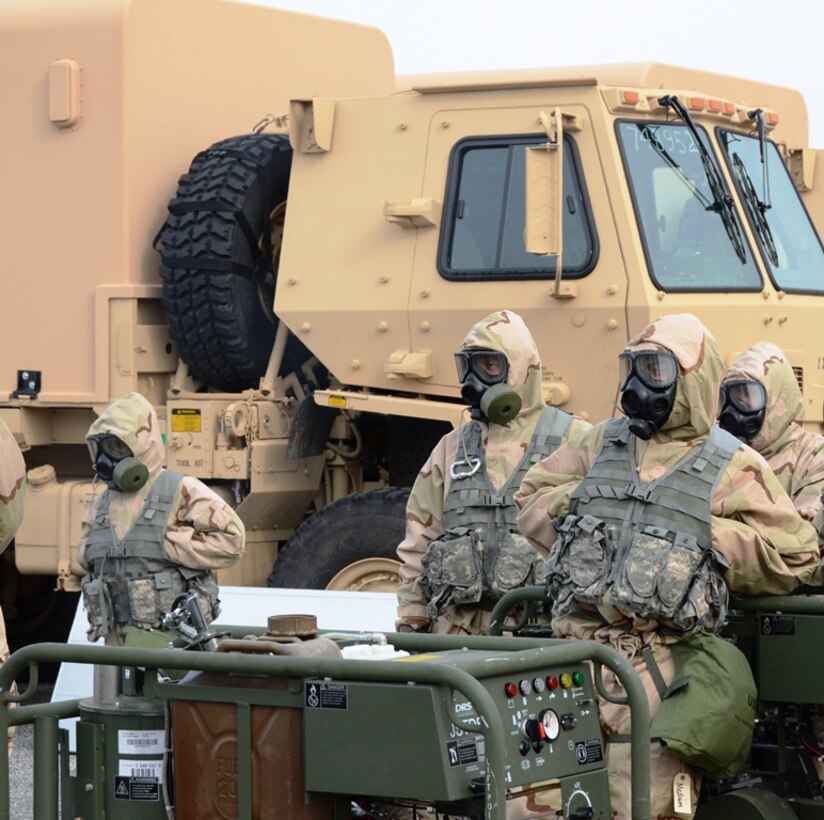 Soldiers from the 231st Chemical Company, Maryland Army National Guard, watch other soldiers decontaminate an A-10C Thunderbolt II from the Maryland Air National Guard on February 8, 2014 at Warfield Air National Guard Base, Baltimore, Md., during a joint training exercise. (Air National Guard photo by Tech. Sgt. David Speicher/RELEASED)