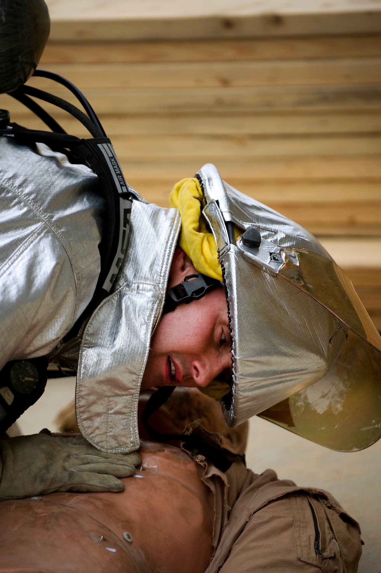 Firefighter Staff Sgt. Jacob Harris, 386th Expeditionary Civil Engineer Squadron, checks for breathing on his "patient" during a training event between the Fire Department and the 386th Expeditionary Medical Squadron on Feb. 2.  The training between the two squadrons enhances the first responders ability to react to actual emergency situations.  (U.S. Air Force photo by Senior Master Sgt. Burke Baker) 