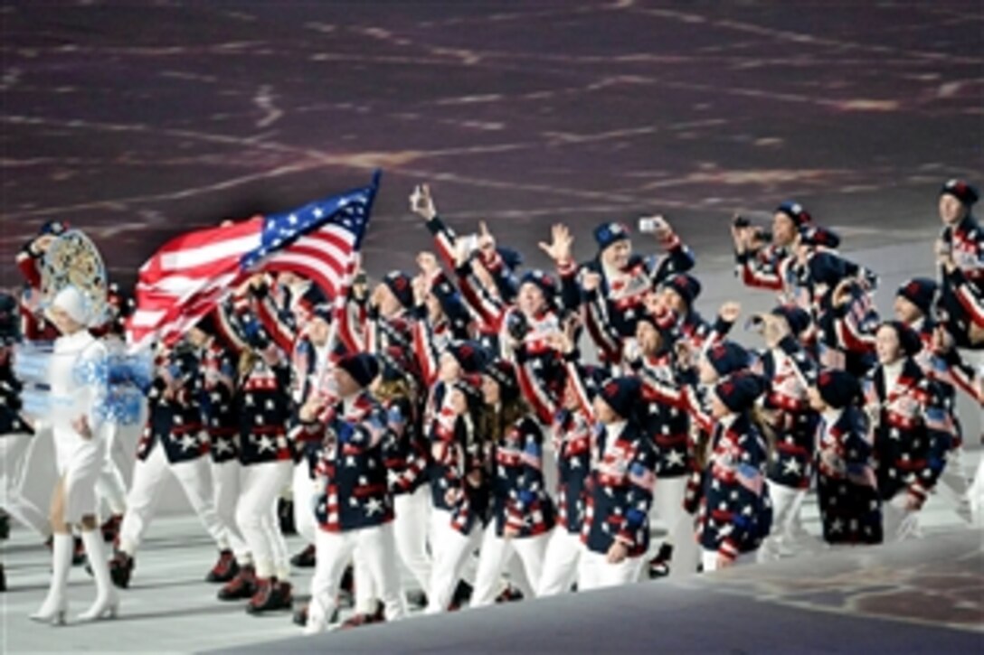 U.S. Army bobsledder Sgt. Dallas Robinson, center with arms upraised, and teammate U.S. Army Capt. Chris Fogt, at Robinson’s right with arms upraised, march into Fisht Olympic Stadium during the opening ceremony of the Sochi 2014 Olympic Winter Games at Olympic Park in Sochi, Russia, Feb. 7, 2014. Robinson, a Kentucky National Guardsman, and Fogt are assigned to the Army’s World Class Athlete program. 