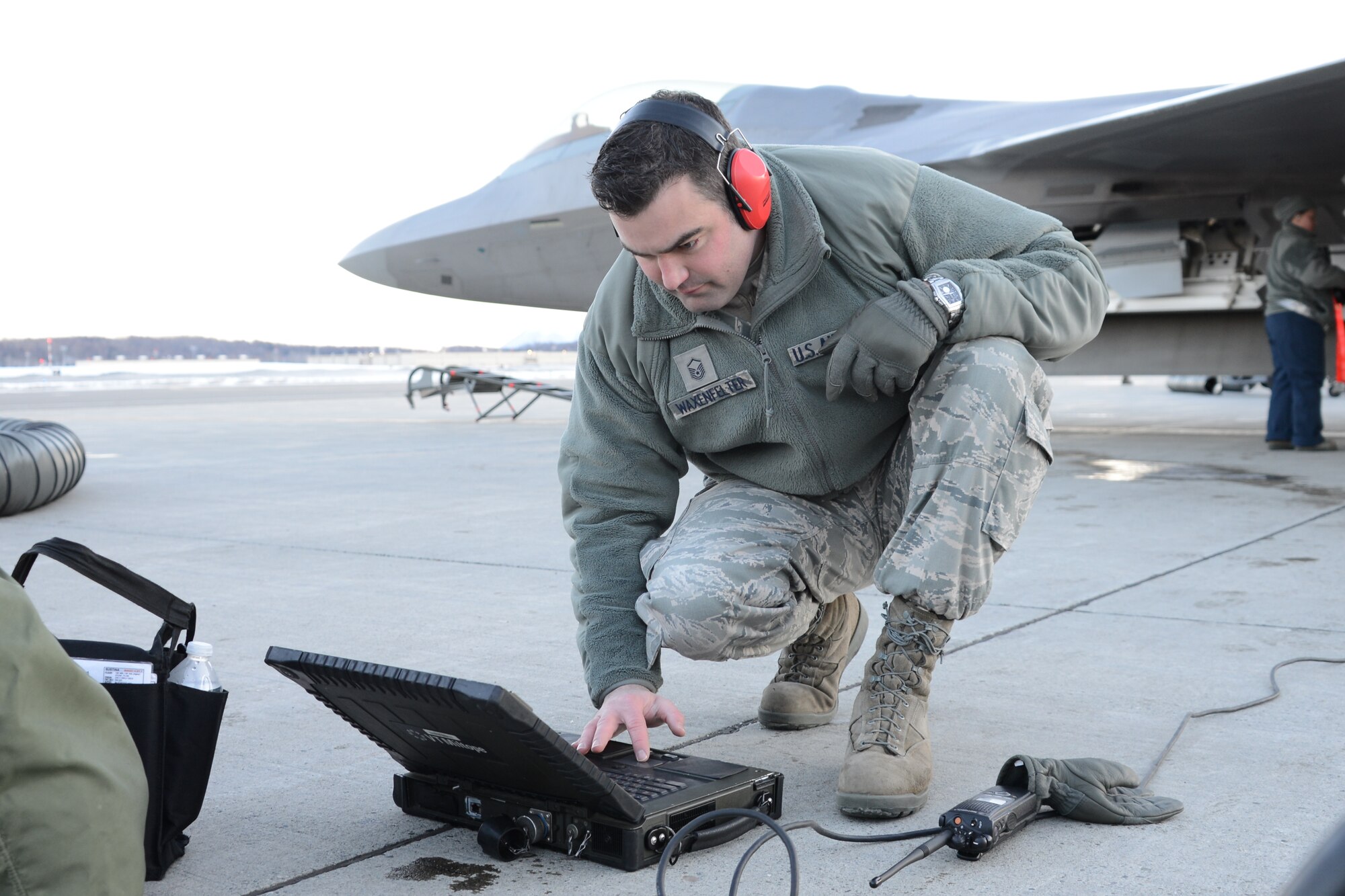 Master Sgt. Benjamin Waxenfelter, 477th Aircraft Maintenance Squadron Production superintendent, checks the forms on the portable maintenance aid prior to signing the exceptional release and handing the aircraft over to the F-22 pilot during the Reserve Unit Training Assembly weekend here Feb. 8. The UTA provides an opportunity for all the Reservists assigned to the 477th Fighter Group to come together and train one weekend a month. (U.S. Air Force/Tech. Sgt. Dana Rosso)