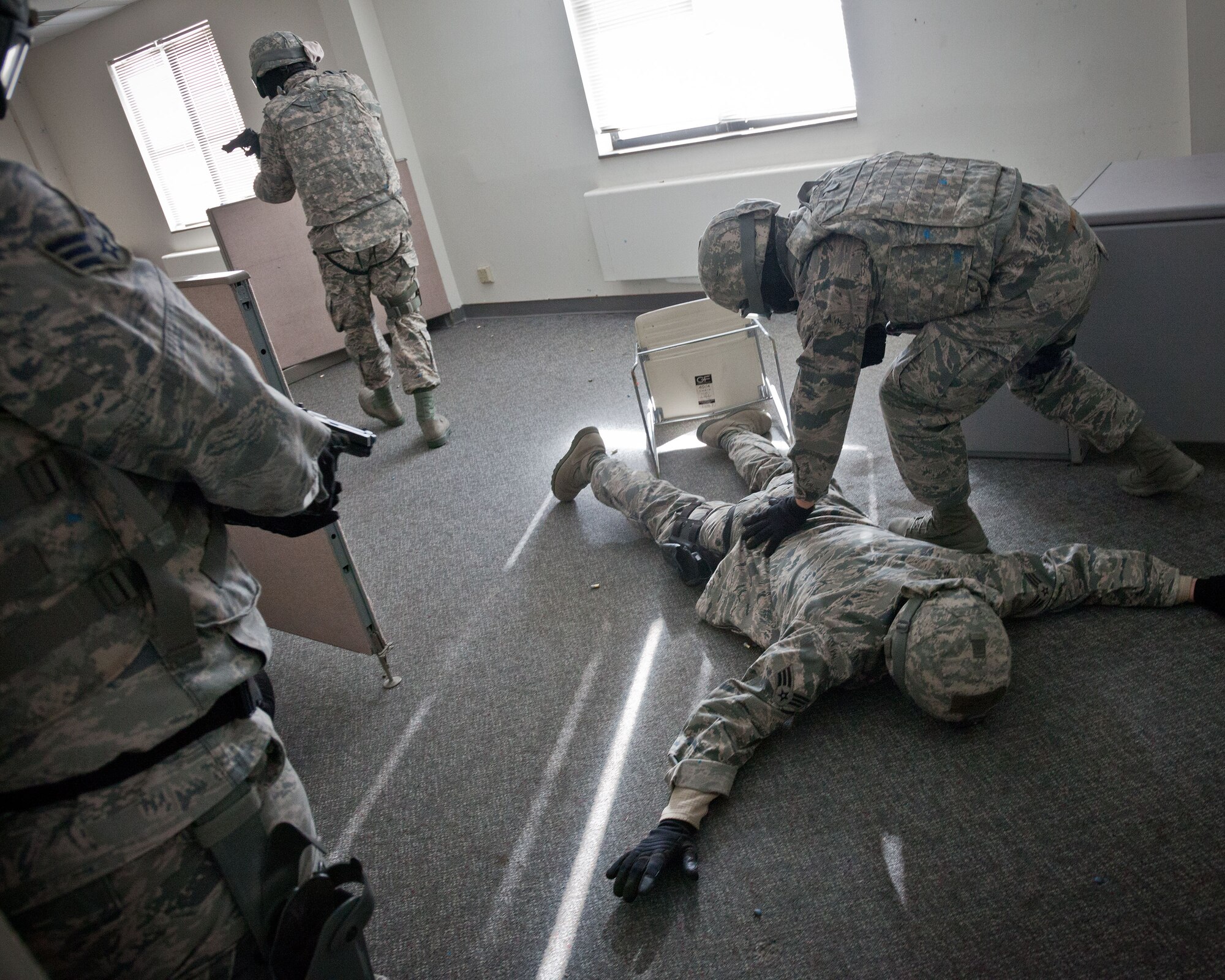 934th Security Forces Squadron Airmen check for weapons while clearing a room. The 934 SFS conducted an active shooter exercise during the Feburary Unit Training Assembly at the old Navy building, Minneapolis-St. Paul Air Reserve Station, Minn. (U.S. Air Force photo by Shannon McKay/Released)