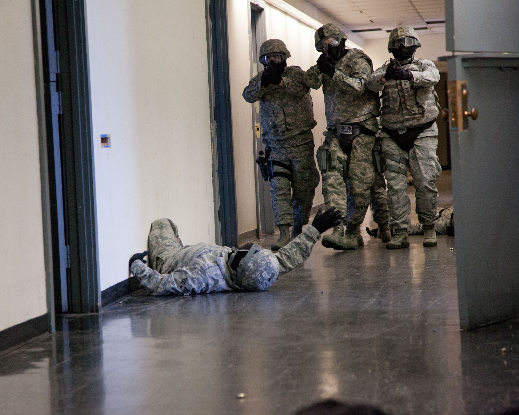 Members of the 934th Security Forces Squadron work in small teams to clear a building as part of an active shooter exercise during the Feburary Unit Training Assembly at the old Navy building, Minneapolis-St. Paul Air Reserve Station, Minn. (U.S. Air Force photo by Shannon McKay/Released)