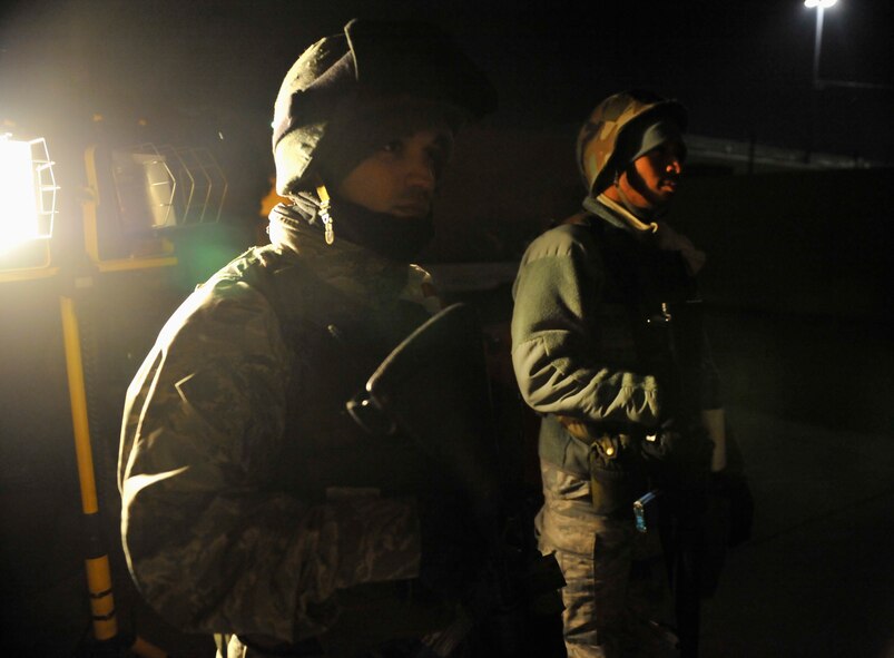 Staff Sgt. Thomas McCarthy and Senior Airman Rick Streeter, both members of the 51st Dental Squadron, guard an entry control point at the base hospital during Operational Readiness Exercise Beverly Midnight 14-02 at Osan Air Base, Republic of Korea, Feb. 9, 2014. Members of the 51st Medical Group ensure only authorized personnel pass through the hospital’s ECPs during exercises like BM 14-02. (U.S. Air Force photo/Senior Airman Siuta B. Ika)