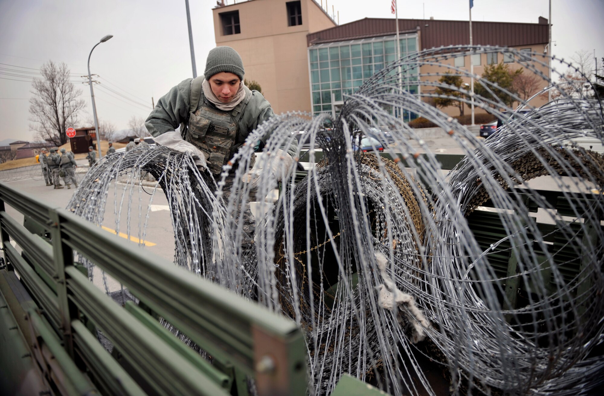 Airman First Class Kevin Garcia, 51st Security Forces Squadron, untangles concertina wire during Operational Readiness Exercise Beverly Midnight 14-02 at Osan Air Base, Republic of Korea, Feb. 9, 2014. Exercises like BM 14-02 test Airmen on their ability to operate and accomplish the mission during war-time contingency operations. (U.S. Air Force photo/Senior Airman Siuta B. Ika)