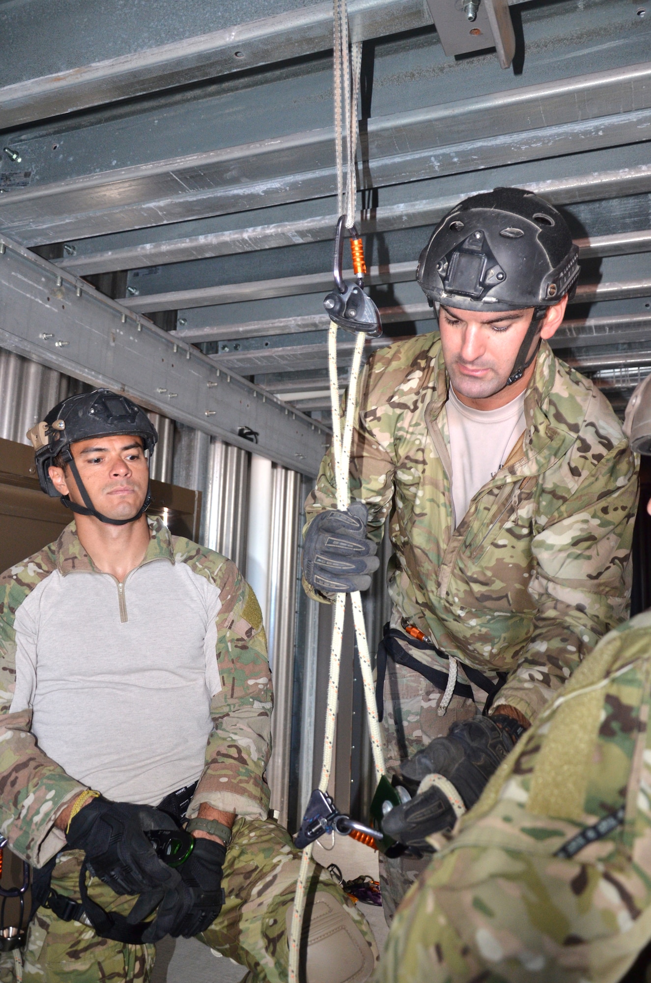 Tech Sgt. Dan Warren, 308th Rescue Squadron reserve pararescueman, talks about different rescue-rope techniques to fellow PJs in the Guardian Angel Training Tower. The tower is specifically designed to prepare them for the battlefield by simulating a variety of rescue environments. (U.S. Air Force photo/2nd Lt. Leslie Forshaw)