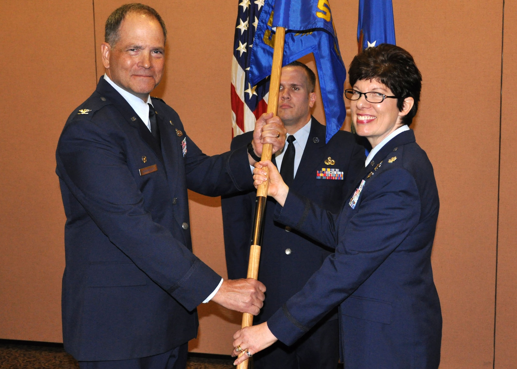 Lt Col Julie Spears assumes command of the 50th Intelligence Squadron during a ceremony February 8, Beale Air Force Base, Calif.  Col Douglas Drakeley, 655th Intelligence Surveillance Reconnaissance Group commander, was on hand to pass the flag. (US Air Force photo/ Senior Airman Adam Hamar)