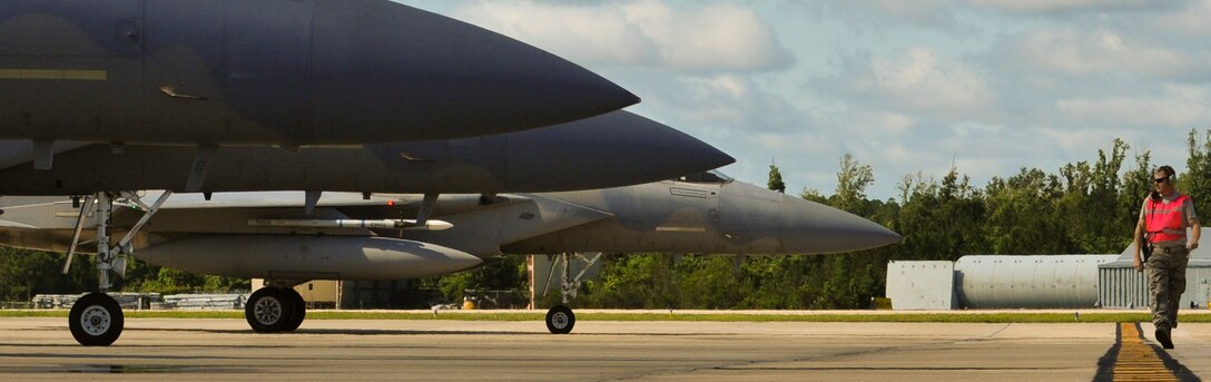 U. S. Air Force Technical Sgt. Rich Verne, an Aircraft Armament Systems Specialist with the 125th Fighter Wing, Florida Air National Guard, walks the line and does final checks on F-15 Eagles prior to marshalling them for take-off from Jacksonville Air National Guard Base, Jacksonville  Fla. June 7, 2013.