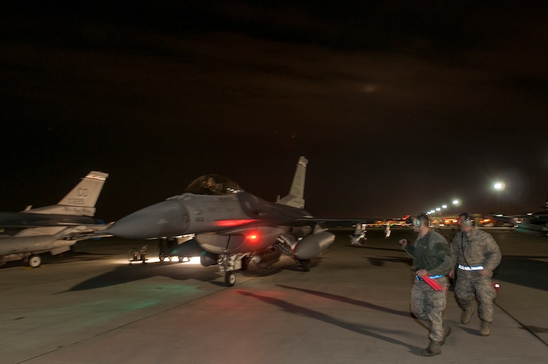 U.S. Air Force Senior Airman Ty McNew (left) and Chief Master Sgt. Edward Hauschild (right),140th Maintenance Squadron, Colorado Air National Guard, conduct preflight-checks on an F-16 Fighting Falcon fighter jet from the 120th Fighter Squadron at Buckley Air Force Base, Colo., before a night training mission at Red Flag 14-1, at Nellis Air Force Base, Nev., Feb. 04, 2014. Combat units come together from the United States and its allied countries to engage in realistic combat training scenarios within Nellis’ 2.9 million acre Test and Training Range Complex. (U.S. Air National Guard photo/Tech. Sgt. Wolfram M. Stumpf)