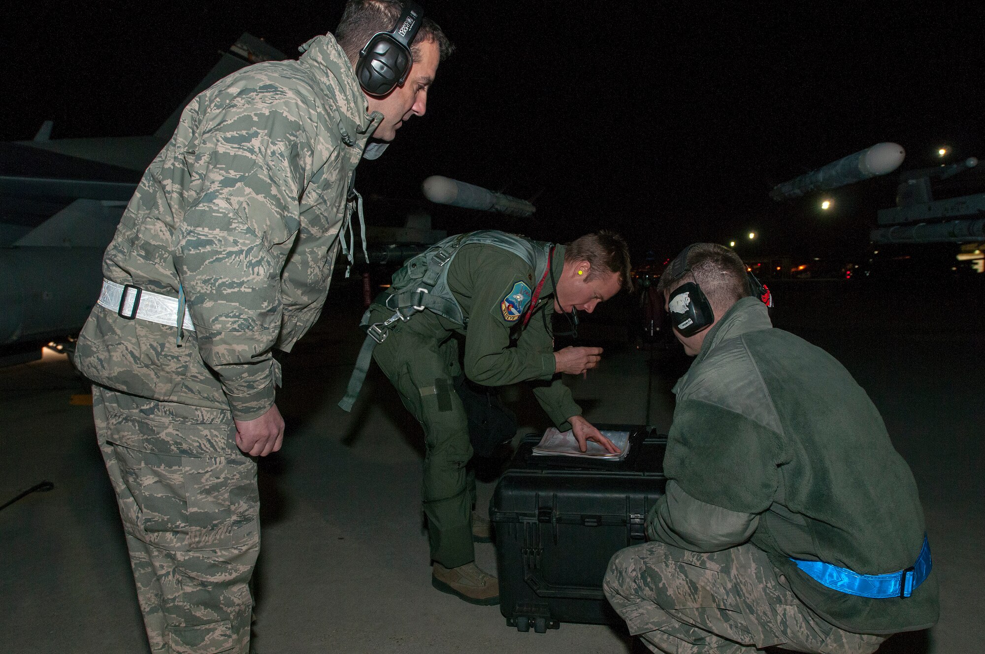 U.S. Air Force Chief Master Sgt. Edward Hauschild (left),140th Maintenance Squadron, Colorado Air National Guard, looks on as Maj. Josh Anderson (center), 120th Fighter Squadron, and Senior Airman Ty Mcnew (right), 140th Maintenance Squadron, begin pre-checks on an F-16 Fighting Falcon fighter jet from the 120th Fighter Squadron at Buckley Air Force Base, Colo., before a night training mission at Red Flag 14-1, at Nellis Air Force Base, Nev., on Feb. 04, 2014. Combat units come together from the United States and its allied countries to engage in realistic combat training scenarios within Nellis’ 2.9 million acre Test and Training Range Complex. (U.S. Air National Guard photo/Tech. Sgt. Wolfram M. Stumpf)