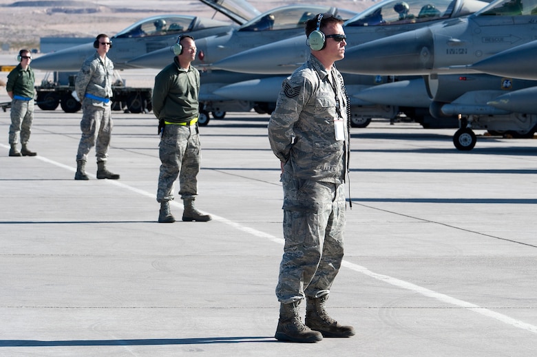 U.S. Air Force crew chiefs from the 140th Maintenance Squadron, Colorado Air National Guard, wait for the signal to launch their F-16 Fighting Falcon fighter jet from the 120th Fighter Squadron at Buckley Air Force Base, Colo., before a training mission at Red Flag 14-1, at Nellis Air Force Base, Nev., Feb. 03, 2014. Combat units come together from the United States and its allied countries to engage in realistic combat training scenarios within Nellis’ 2.9 million acre Test and Training Range Complex. (U.S. Air National Guard photo/Tech. Sgt. Wolfram M. Stumpf)
