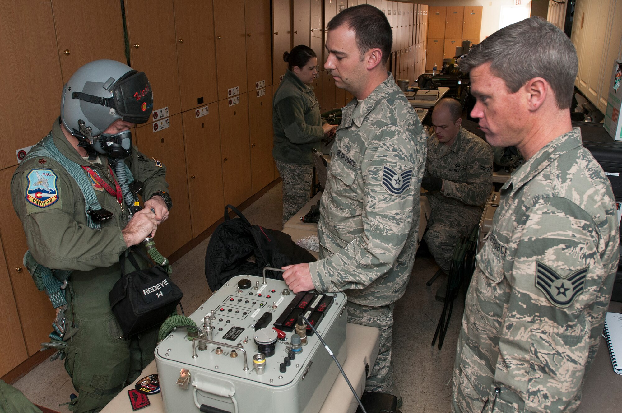 U.S. Air Force Maj. Jeremiah Tucker (left), 120th Fighter Squadron, Colorado Air National Guard tests his flight equipment with Tech. Sgt. Jared McCartney (center) and Staff Sgt. Joshua Frizzell (right), 140th Operations Support Squadron, during Red Flag 14-1, at Nellis Air Force Base, Nev., Feb. 03, 2014. Combat units come together from the United States and its allied countries to engage in realistic combat training scenarios within Nellis’ 2.9 million acre Test and Training Range Complex. (U.S. Air National Guard photo/Tech. Sgt. Wolfram M. Stumpf)