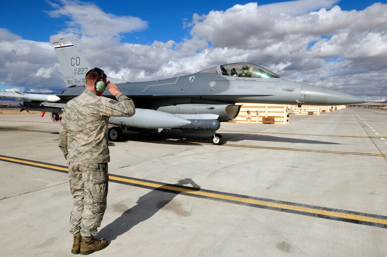 U.S. Air Force Tech. Sgt. Jacob Adams, 140th Maintenance Squadron, Colorado Air National Guard, salutes Maj. Michael Gommel, who is piloting an F-16 Fighting Falcon from the 120th Fighter Squadron at Buckley Air Force Base, Colo., just before a training mission at Red Flag 14-1, at Nellis Air Force Base, Nev., Jan. 31, 2014. Combat units come together from the United States and its allied countries to engage in realistic combat training scenarios within Nellis’ 2.9 million acre Test and Training Range Complex. (U.S. Air National Guard photo/Tech. Sgt. Wolfram M. Stumpf)