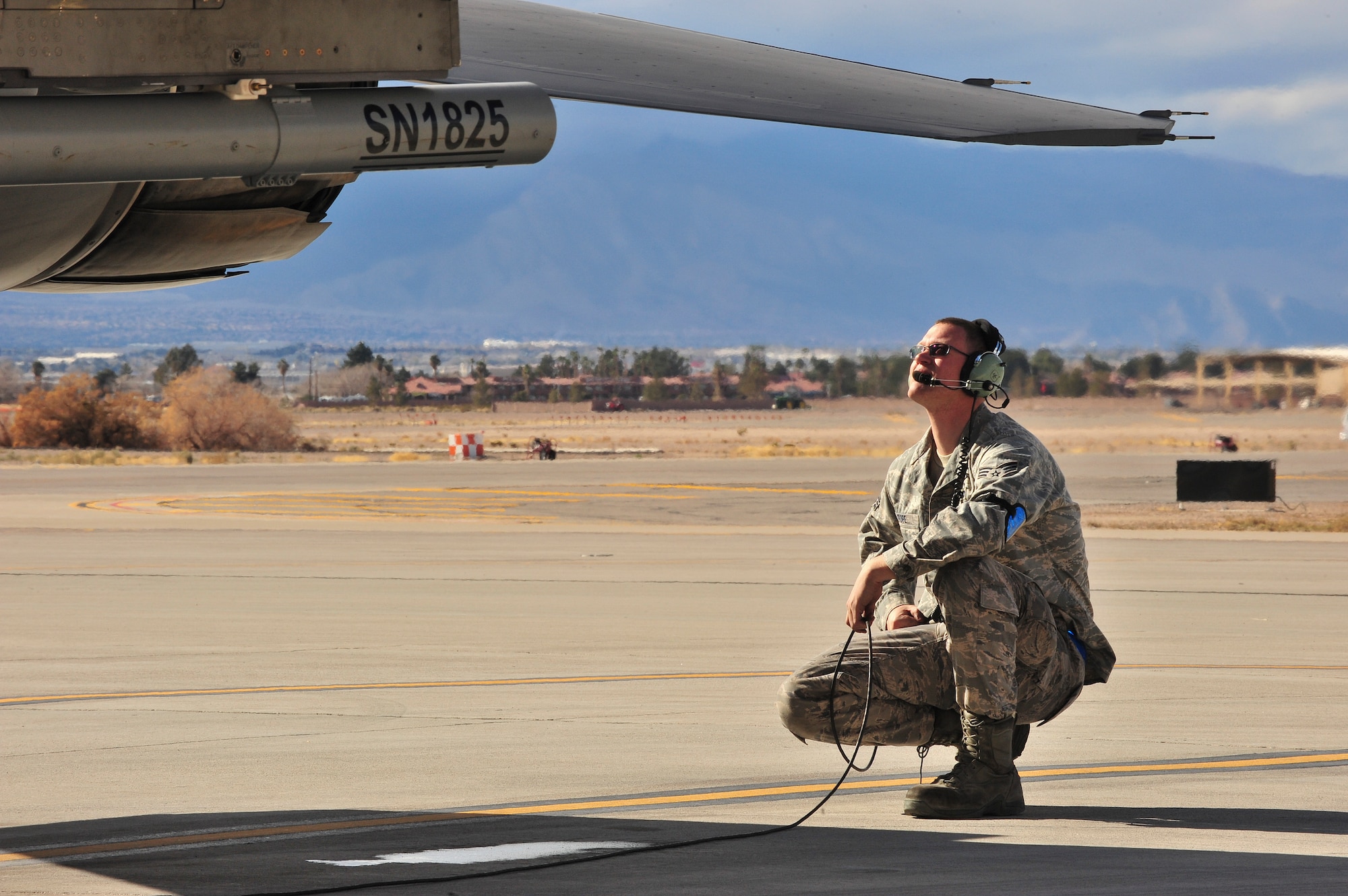 U.S. Air Force Senior Airman Michael Pope, 140th Maintenance Squadron, Colorado Air National Guard, relays information back to the pilot of an F-16 Falcon fighter jet from the 120th Fighter Squadron at Buckley Air Force Base, Colo., during final aircraft checks at Red Flag 14-1, at Nellis Air Force Base, Nev., Jan. 31, 2014. Combat units come together from the United States and its allied countries to engage in realistic combat training scenarios within Nellis’ 2.9 million acre Test and Training Range Complex. (U.S. Air National Guard photo/Tech. Sgt. Wolfram M. Stumpf)