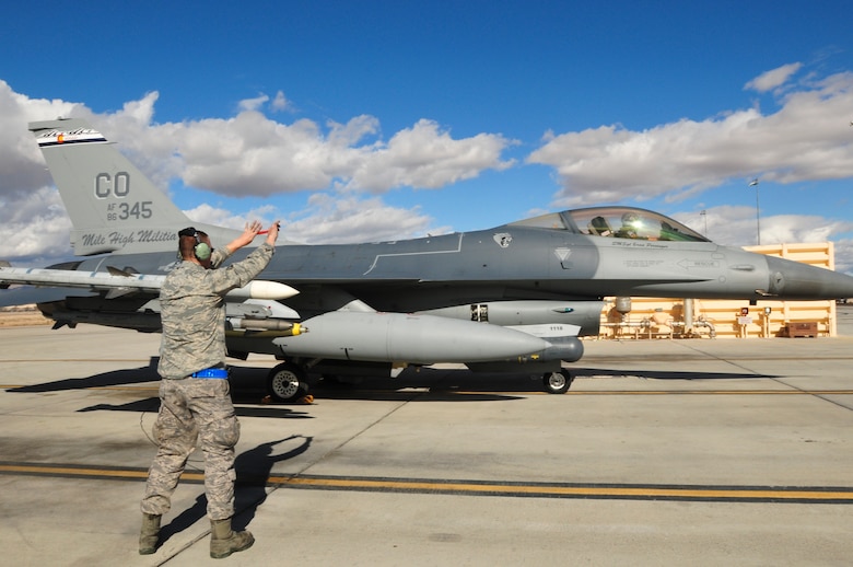 U.S. Air Force Senior Airman Michael Pope, 140th Maintenance Squadron, Colorado Air National Guard, shows the pilot in an F-16 Fighting Falcon fighter jet from the 120th Fighter Squadron at Buckley Air Force Base, Colo., that a safety tag has been removed before a training mission at Red Flag 14-1, at Nellis Air Force Base, Nev., Jan. 31, 2014. Combat units come together from the United States and its allied countries to engage in realistic combat training scenarios within Nellis’ 2.9 million acre Test and Training Range Complex. (U.S. Air National Guard photo/Tech. Sgt. Wolfram M. Stumpf)