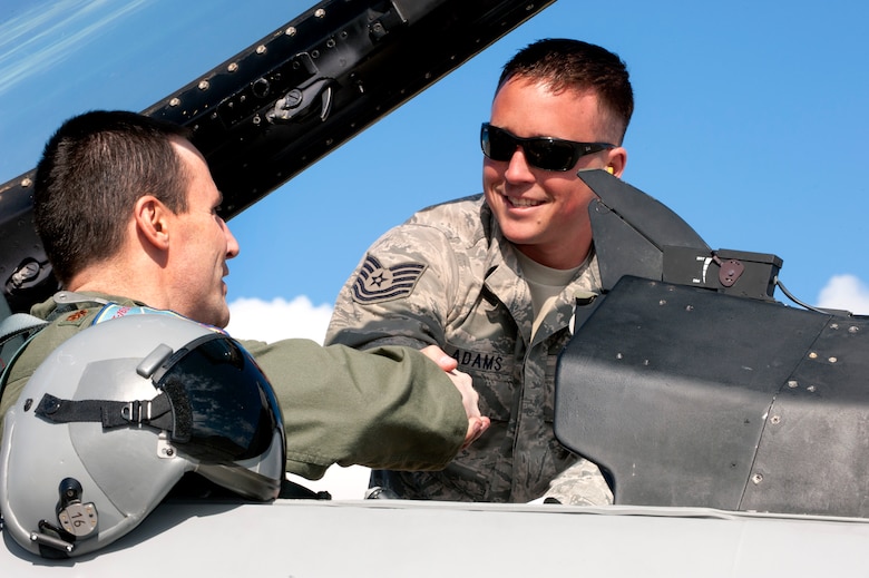 U.S. Air Force Maj. Michael Gommel (left), 120th Fighter Squadron, shakes hands with Tech. Sgt. Jacob Adams, 140th Maintenance Squadron, Buckley Air Force Base, Colorado Air National Guard, before starting pre-flight checks on an F-16 Fighting Falcon during Red Flag 14-1, at Nellis Air Force Base, Nev., Jan. 31, 2014. Combat units come together from the United States and its allied countries to engage in realistic combat training scenarios within Nellis’ 2.9 million acre Test and Training Range Complex. (U.S. Air National Guard photo/Tech. Sgt. Wolfram M. Stumpf/Released)