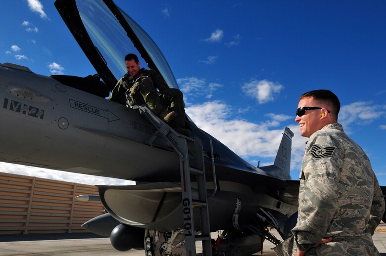 U.S. Air Force Maj. Michael Gommel (left), 120th Fighter Squadron, shares a laugh with Crew Chief Tech. Sgt. Jacob Adams, 140th Maintenance Squadron, Buckley Air Force Base, Colorado Air National Guard, before starting pre-flight checks on an F-16 Fighting Falcon during Red Flag 14-1, at Nellis Air Force Base, Nev., Jan. 31, 2014. Combat units come together from the United States and its allied countries to engage in realistic combat training scenarios within Nellis’ 2.9 million acre Test and Training Range Complex. (U.S. Air National Guard photo/Tech. Sgt. Wolfram M. Stumpf)