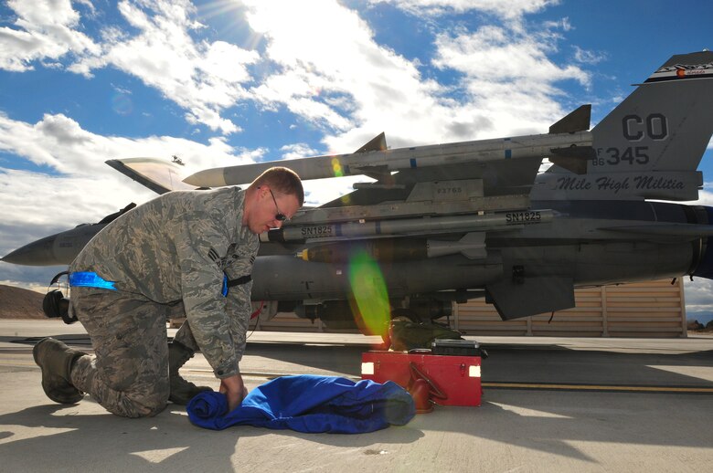 U.S. Air National Guard Senior Airman Michael Pope, 140th Maintenance Squadron, Colorado Air National Guard, readies an F-16 Fighting Falcon fighter jet from the 120th Fighter Squadron at Buckley Air Force Base, Colo., before a training mission at Red Flag 14-1, at Nellis Air Force Base, Nev., Jan. 31, 2014. Combat units come together from the United States and its allied countries to engage in realistic combat training scenarios within Nellis’ 2.9 million acre Test and Training Range Complex. (U.S. Air National Guard photo/Tech. Sgt. Wolfram M. Stumpf)