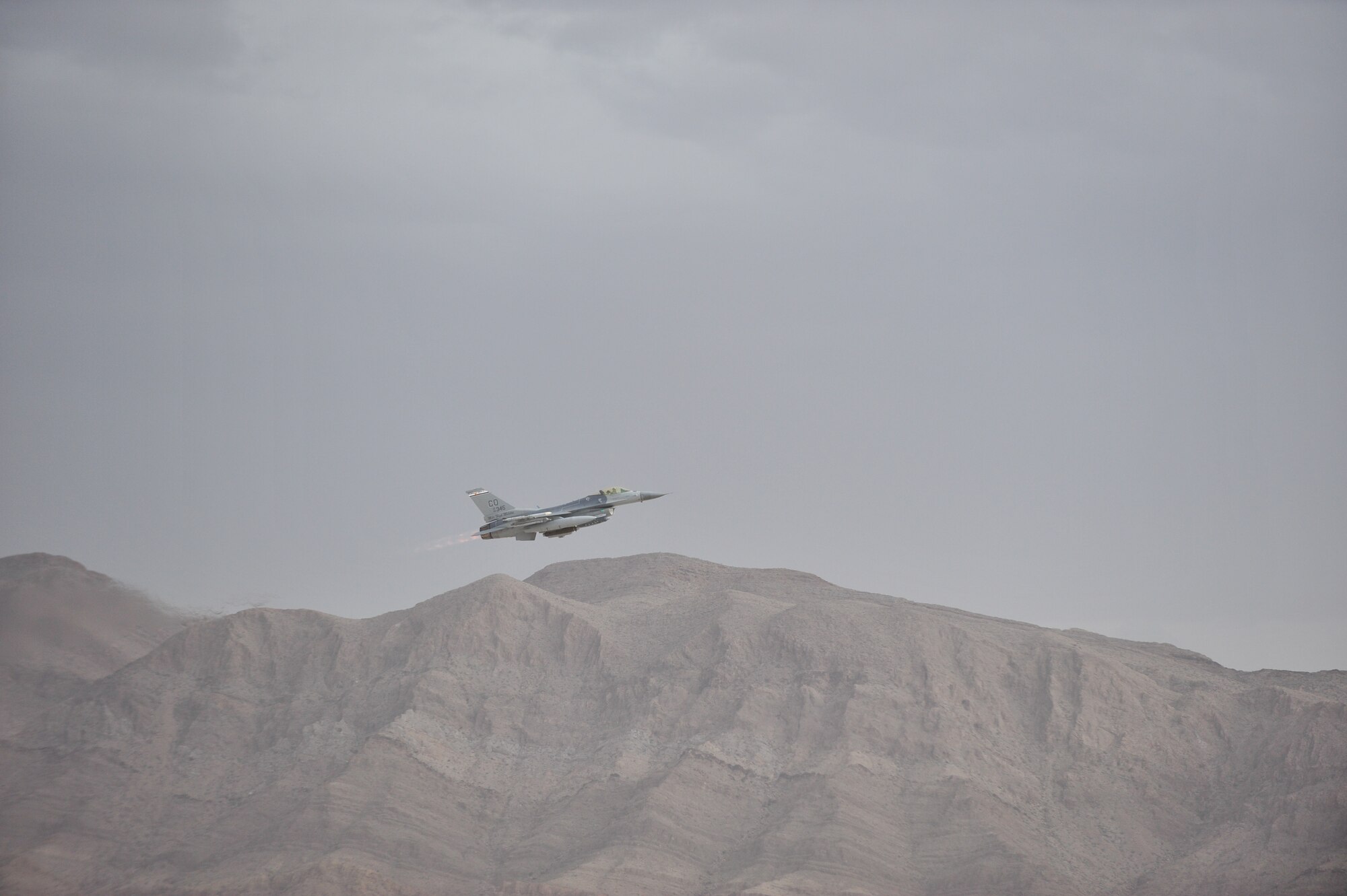 An F-16 Fighting Falcon takes off for a training mission during Red Flag 14-1, at Nellis Air Force Base, Nev., Jan. 30, 2014. Combat units come together from the United States and its allied countries to engage in realistic combat training scenarios within Nellis’ 2.9 million acre Test and Training Range Complex. The F-16 is assigned to the 120th Fighter Squadron at Buckley Air Force Base, Colorado Air National Guard.  (U.S. Air National Guard photo by Tech. Sgt. Wolfram M. Stumpf)