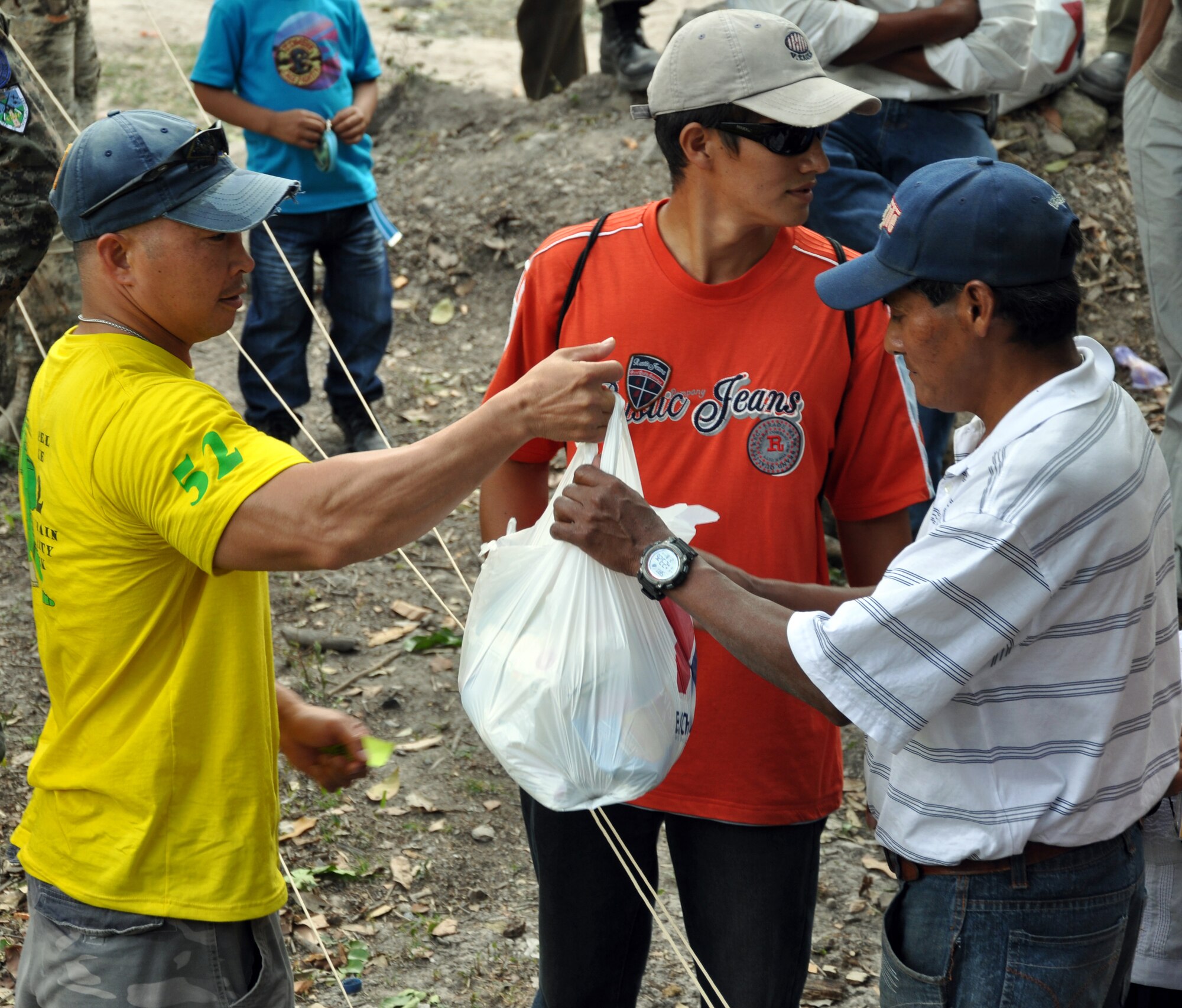 U.S. Army Sgt. Maj. Thinh Huynh, Army Forces Battalion, delivers a bag of food to a Honduran family during the 52nd Joint Task Force-Bravo "Chapel Hike" in Honduras, Feb. 8, 2014.  More than 120 members of Joint Task Force-Bravo spent the day delivering more than 2,400 pounds of food and medical supplies to families in need in the mountain village of La Laguna, Honduras.  To deliver the supplies, Task Force members carried the items on a more than seven-mile round trip hike, with an elevation gain of 1,700 feet.  All of the food and supplies were purchased with funds donated by Task Force members.  (U.S. Air Force photo by Capt. Zach Anderson)  