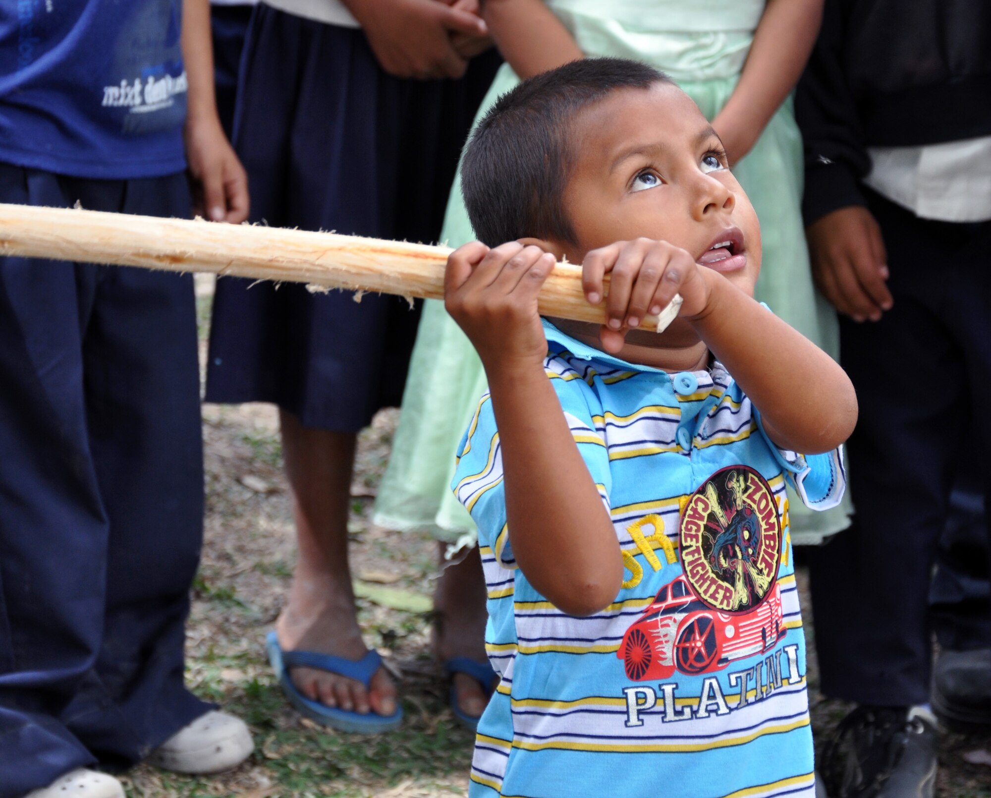 A young Honduran boy prepares to take a swing at a pinata during the 52nd Joint Task Force-Bravo "Chapel Hike" in Honduras, Feb. 8, 2014.  More than 120 members of Joint Task Force-Bravo spent the day delivering more than 2,400 pounds of food and medical supplies to families in need in the mountain village of La Laguna, Honduras.  To deliver the supplies, Task Force members carried the items on a more than seven-mile round trip hike, with an elevation gain of 1,700 feet.  All of the food and supplies were purchased with funds donated by Task Force members.  (U.S. Air Force photo by Capt. Zach Anderson)  