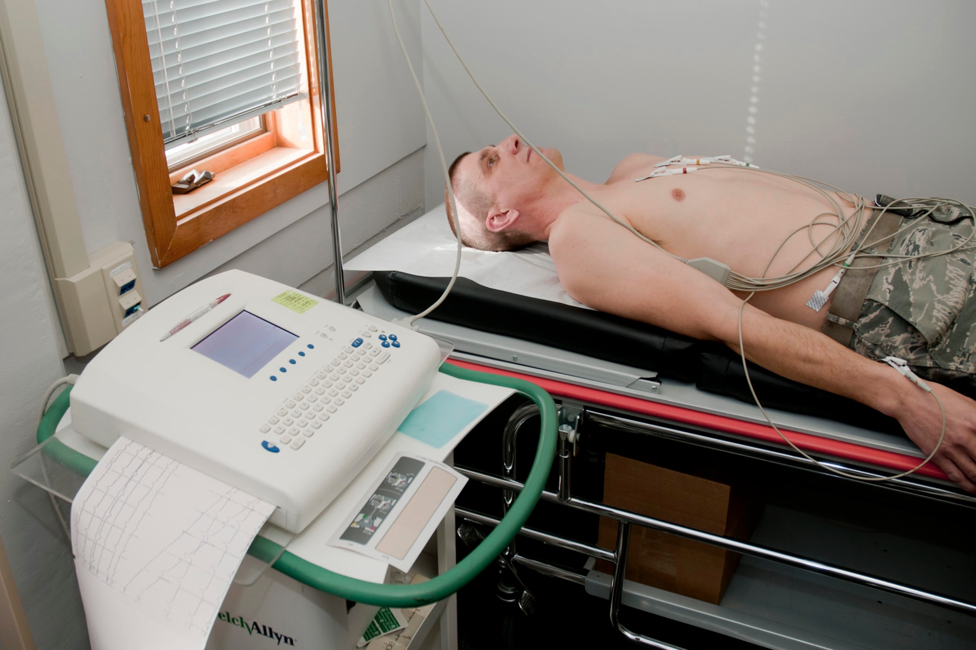 Master Sgt. Mike Johnson is hooked up to an electrocardiogram (EKG) machine for simulated testing on his heart in the exam room of the 132nd Fighter Wing (132FW) Medical Facility, Des Moines, Iowa on February 7, 2014.  (U.S. Air National Guard photo by Staff Sgt. Linda K. Burger/Released)