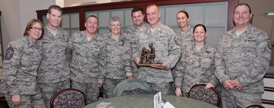 Master Sgt. Jeff Hall, former First Sergeant for the Aerospace Medical Squadron, 932nd Airlift Wing, is presented the First Sergeant Trophy by fellow First Sergeant council members, Feb. 8, 2014 at Scott Air Force Base.  Hall returns to his former career with the 12th Operational Weather Flight after serving three years as a First Sergeant.  (U.S. Air Force photo / Tech. Sgt. Christopher Parr)