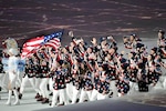U.S. Army bobsledder Sgt. Dallas Robinson, center with arms upraised, and teammate U.S. Army Capt. Chris Fogt, at Robinson’s right with arms upraised, march into Fisht Olympic Stadium during the opening ceremony of the Sochi 2014 Olympic Winter Games at Olympic Park in Sochi, Russia, Feb. 7, 2014. Robinson, a Kentucky National Guardsman, and Fogt are assigned to the Army’s World Class Athlete program. U.S. Army photo by Tim Hipps