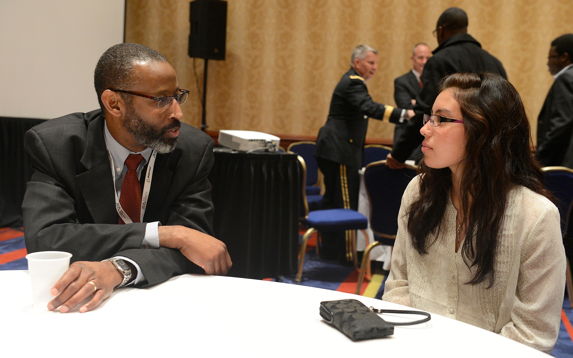 Timothy K. Bridges, Deputy Assistant Secretary of the Air Force for Installations, Headquarters Air Force, Pentagon, Washington, D.C., talks with Giselle Gonzales, of Hayfield Secondary School, Alexandria, Va., during the Black Engineer of the Year Science, Technology Engineering and Mathematics conference, during mentorship session in Washington, D.C., Feb. 7, 2014.  (U.S. Air Force photo/Scott M. Ash)