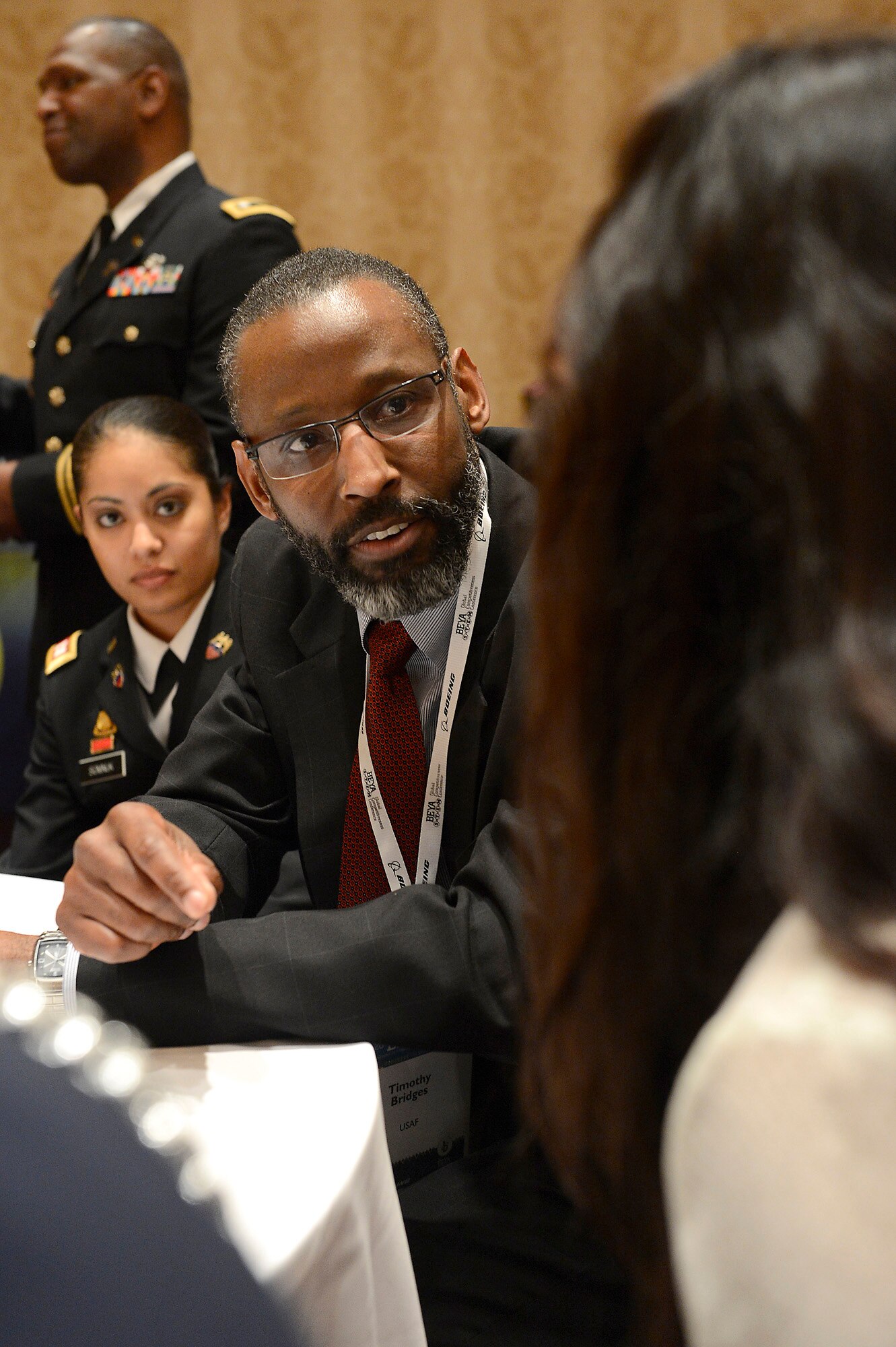 Timothy K. Bridges, Deputy Assistant Secretary of the Air Force for Installations, Headquarters Air Force, Pentagon, Washington, D.C., talks with Giselle Gonzales, of Hayfield Secondary School, Alexandria, Va., during the Black Engineer of the Year Science, Technology Engineering and Mathematics conference, during mentorship session in Washington, D.C., Feb. 7, 2014.  (U.S. Air Force photo/Scott M. Ash)