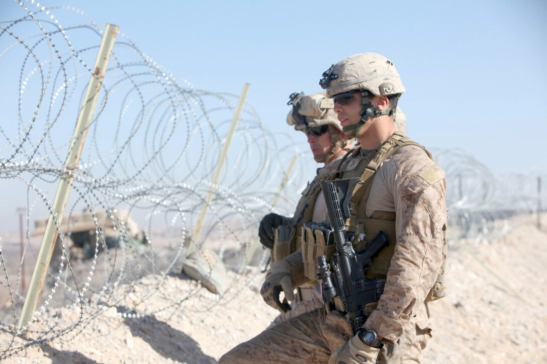 Cpl. Robert Santiago, front, from Perth Amboy, N.J., and Sgt. Eddie Glowacki, from Great Valley, N.Y., Security Force Assistance Advisor Team 2-215, look out over the Sangin Valley during an operation near Forward Operating Base Nolay, Afghanistan, Jan. 27, 2014. The SFAAT considered the operation to be a success and was dedicated to helping the ANA in the region to become completely sustainable and self-sufficient. (Marine Corps photo by Cpl. Joshua Young)