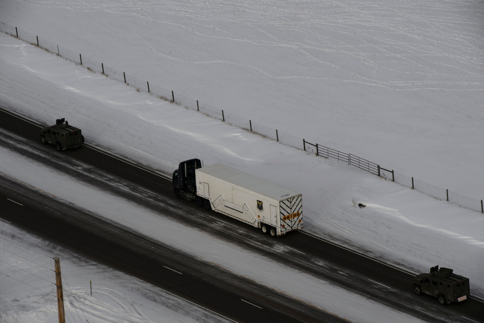 Missile maintenance teams from the 341st Missile Maintenance Squadron are escorted by security forces members from the 741st Missile Security Forces Squadron as they perform a missile maintenance convoy Feb. 7, 2014, at Malmstrom Air Force Base, Mont. Airmen from the 341st MMXS later removed and installed a new reentry system at the ICBM launch facility. (U.S. Air Force photo/Staff Sgt. Jonathan Snyder) 