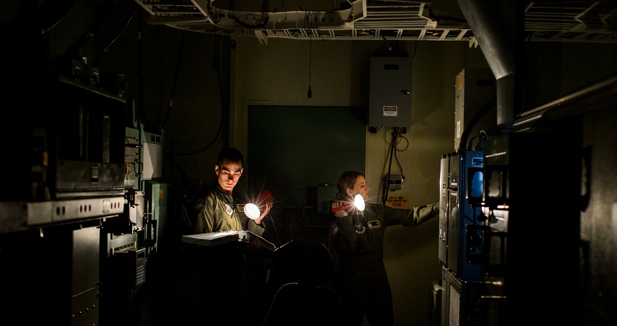 Capt. Robert Shannon (left) and Capt. Brooke Lake go through a launch procedure checklist during simulation training Feb. 6, 2014, at Malmstrom Air Force Base, Mont. The 341st OSS trains missile crews, missile alert facility managers and chefs to ensure they are proficient and combat ready. Shannon is the 341st Operations Support Squadron missile combat crew commander and Lake is the 341st OSS missile combat crew commander instructor. (U.S. Air Force photo/Staff Sgt. Jonathan Snyder)
  