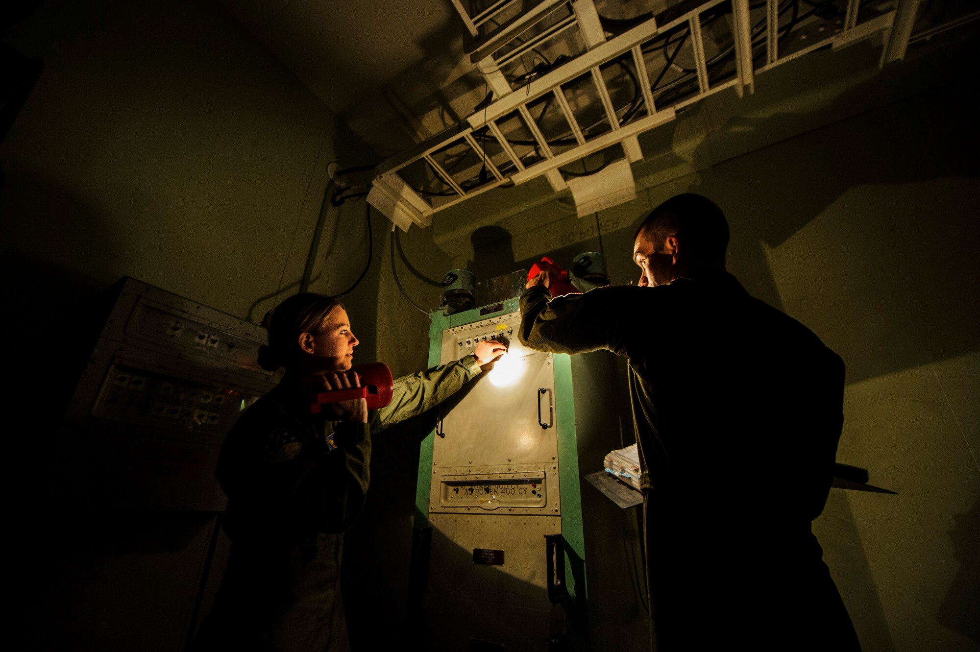 Capt. Brooke Lake (left) and Capt. Robert Shannon go through a launch procedure checklist during simulation training Feb. 6, 2014, at Malmstrom Air Force Base, Mont. The 341st OSS trains missile crews, missile alert facility managers and chefs to ensure they are proficient and combat ready. Lake is the 341st OSS missile combat crew commander instructor and Shannon is the 341st Operations Support Squadron missile combat crew commander. (U.S. Air Force photo/Staff Sgt. Jonathan Snyder)
  