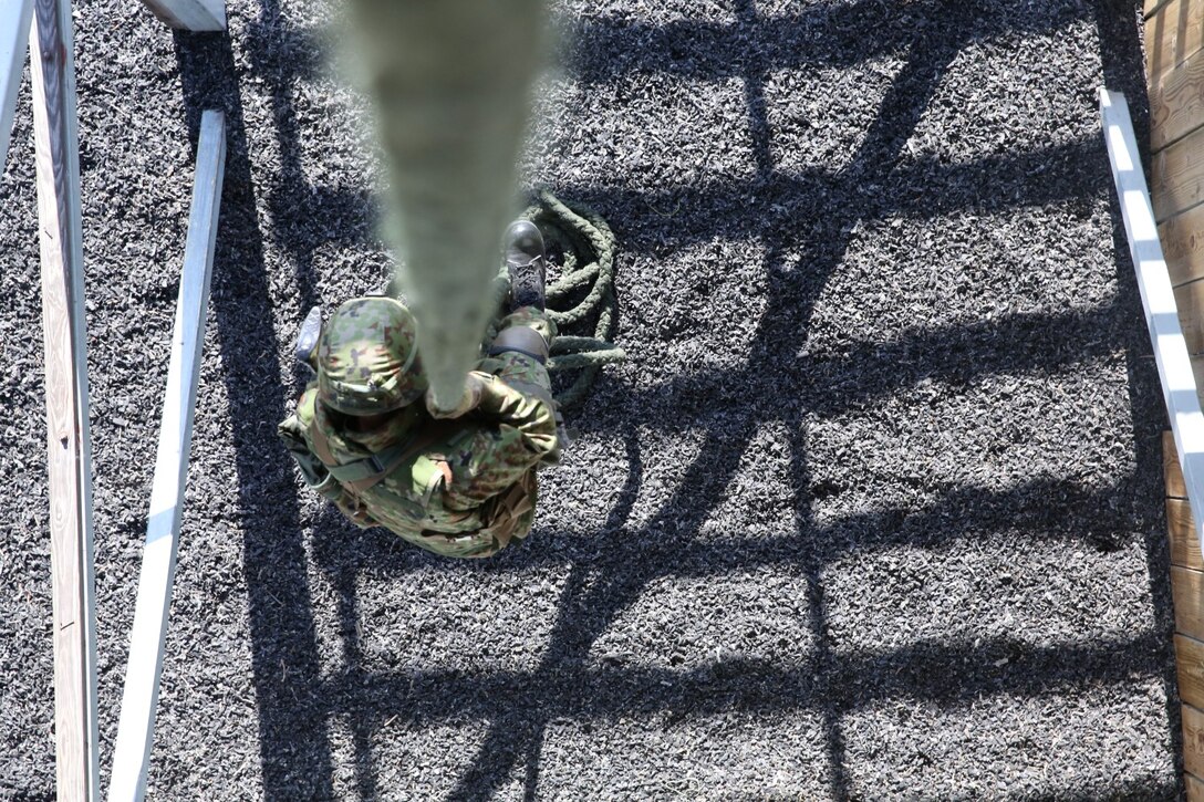 A soldier with the Japan Ground Self-Defense Force descends from a 30-foot tower while performing fast-rope insertion training during Exercise Iron Fist 2014 aboard Camp Pendleton, Calif., Feb. 5, 2014. Iron Fist is an amphibious exercise that brings together Marines and sailors from the 15th Marine Expeditionary Unit, other I Marine Expeditionary Force units, and soldiers from the JGSDF, to promote military interoperability and hone individual and small-unit skills through challenging, complex and realistic training. 