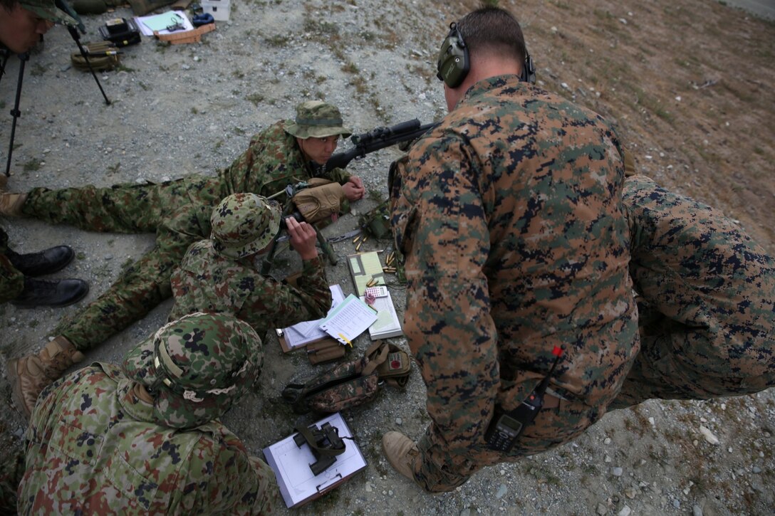 A U.S. Marine, pre-scout sniper instructor, Division Schools, explains sniper-shooting techniques to soldiers from the Japan Ground Self-Defense Force during Exercise Iron Fist 2014 aboard Camp Pendleton, Calif., Jan. 6, 2014. Iron Fist is an amphibious exercise that brings together Marines and sailors from the 15th Marine Expeditionary Unit, other I Marine Expeditionary Force units, and soldiers from the JGSDF, to promote military interoperability and hone individual and small-unit skills through challenging, complex and realistic training. 