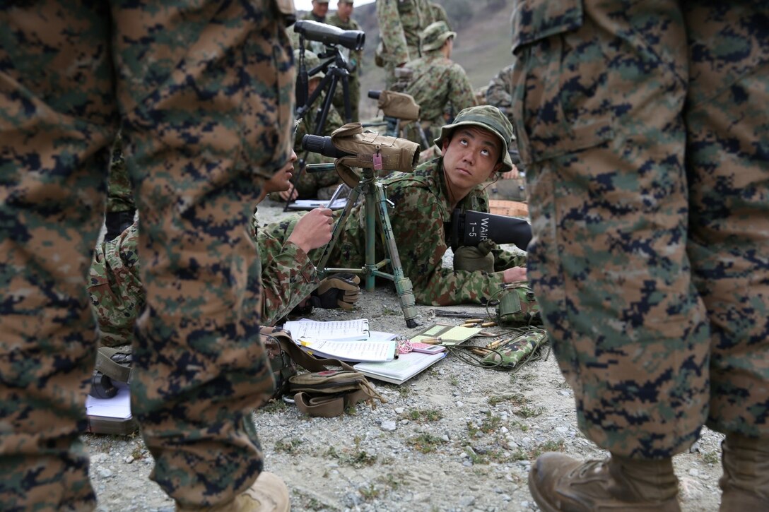 A soldier with the Japan Ground Self-Defense Force listens to Division Schools instructors while conducting an unknown distance drill during Exercise Iron Fist 2014 aboard Camp Pendleton, Calif., Feb. 6, 2014. Iron Fist is an amphibious exercise that brings together Marines and sailors from the 15th Marine Expeditionary Unit, other I Marine Expeditionary Force units, and soldiers from the JGSDF, to promote military interoperability and hone individual and small-unit skills through challenging, complex and realistic training. 