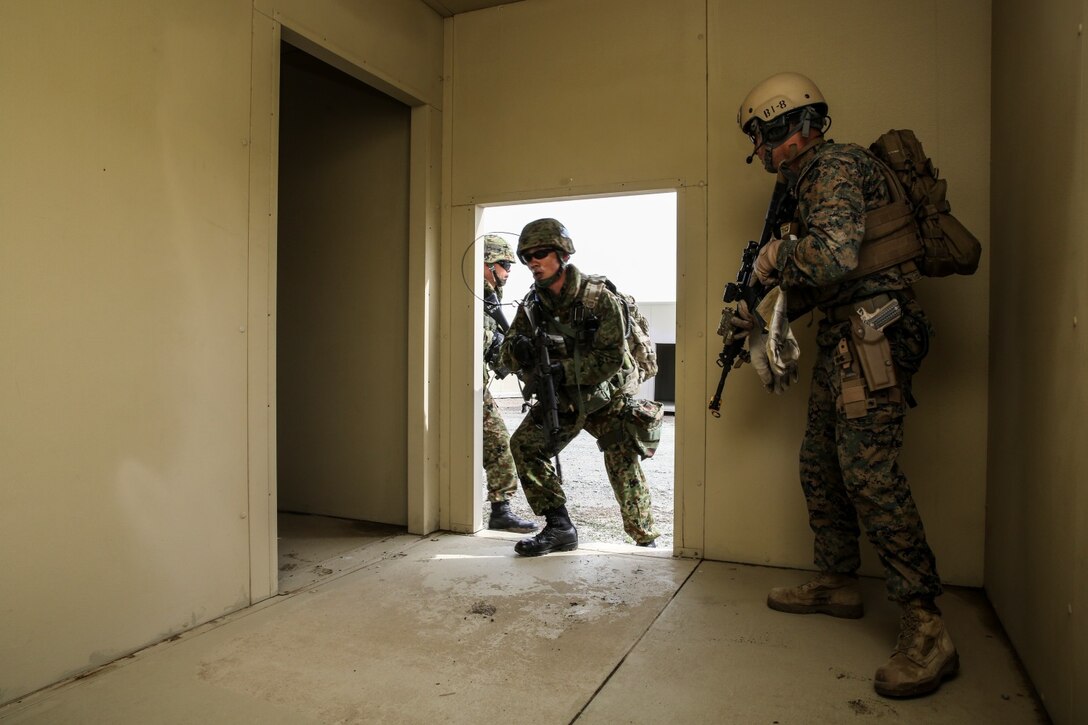 U.S. Marines with 1st Reconnaissance Battalion, 1st Marine Division, and soldiers from the Japan Ground Self-Defense Force clear a building while conducting raid training during Exercise Iron Fist 2014 aboard Camp Pendleton, Calif., Feb. 7, 2014. Iron Fist is an amphibious exercise that brings together Marines and sailors from the 15th Marine Expeditionary Unit, other I Marine Expeditionary Force units, and soldiers from the JGSDF, to promote military interoperability and hone individual and small-unit skills through challenging, complex and realistic training. 