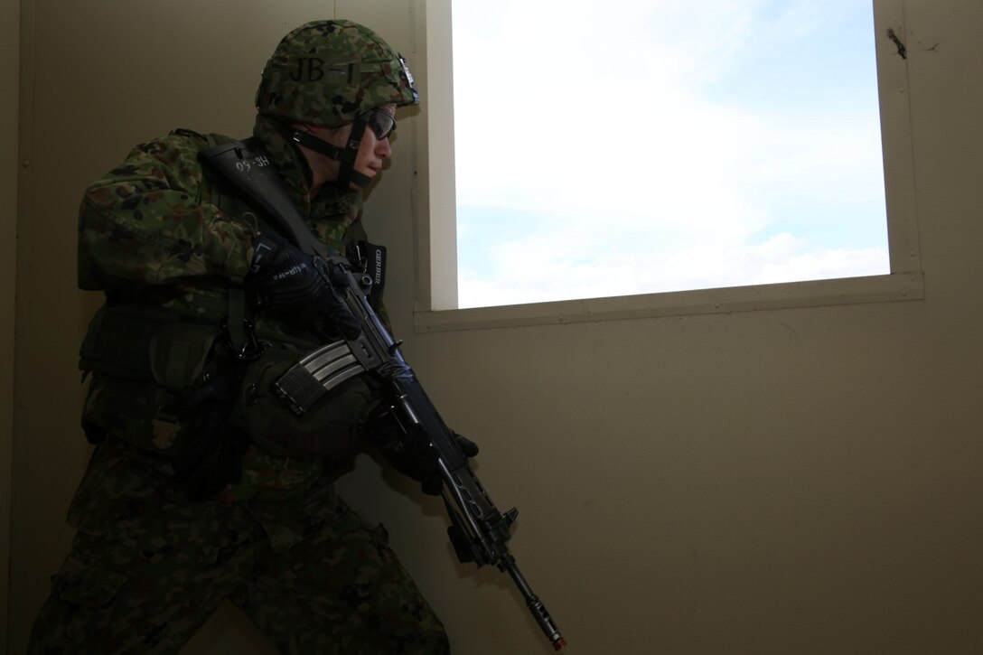 A U.S. Marine with 1st Reconnaissance Battalion, 1st Marine Division, and soldiers from the Japan Ground Self-Defense Force exit a building and move toward their next objective while conducting raid training during Exercise Iron Fist 2014 aboard Camp Pendleton Calif., Feb. 7, 2014. Iron Fist is an amphibious exercise that brings together Marines and sailors from the 15th Marine Expeditionary Unit, other I Marine Expeditionary Force units and soldiers from the JGSDF, to promote military interoperability and hone individual and small-unit skills through challenging, complex and realistic training. 