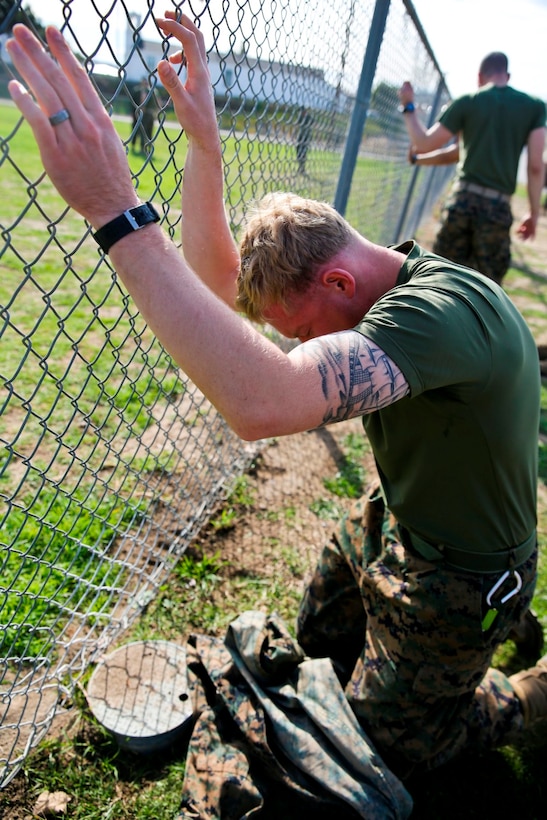 Cpl. Scott Reel, combat correspondent with I Marine Expeditionary Force, from Naperville, Ill., feels the effects Oleoresin Capsicum spray as a part of non-lethal weapons training aboard Camp Pendleton, Calif., Feb. 4. After being sprayed, the Marines run a detaining course to ensure they can complete their mission while being contaminated.