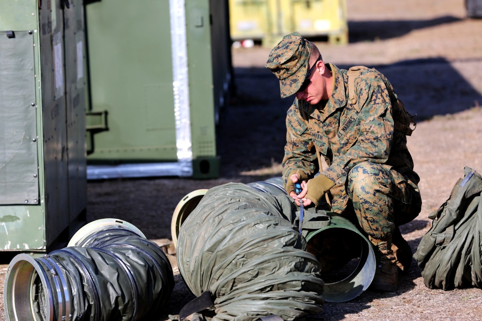 Lance Cpl. Alexander J. Smith, a field radio repairman with 9th Communication Battalion, links tubing together at a combat operations center exercise aboard Camp Pendleton, Calif., Feb. 5. The exercise created a realistic environment for Marines to quickly and effectively establishes a center of operations.