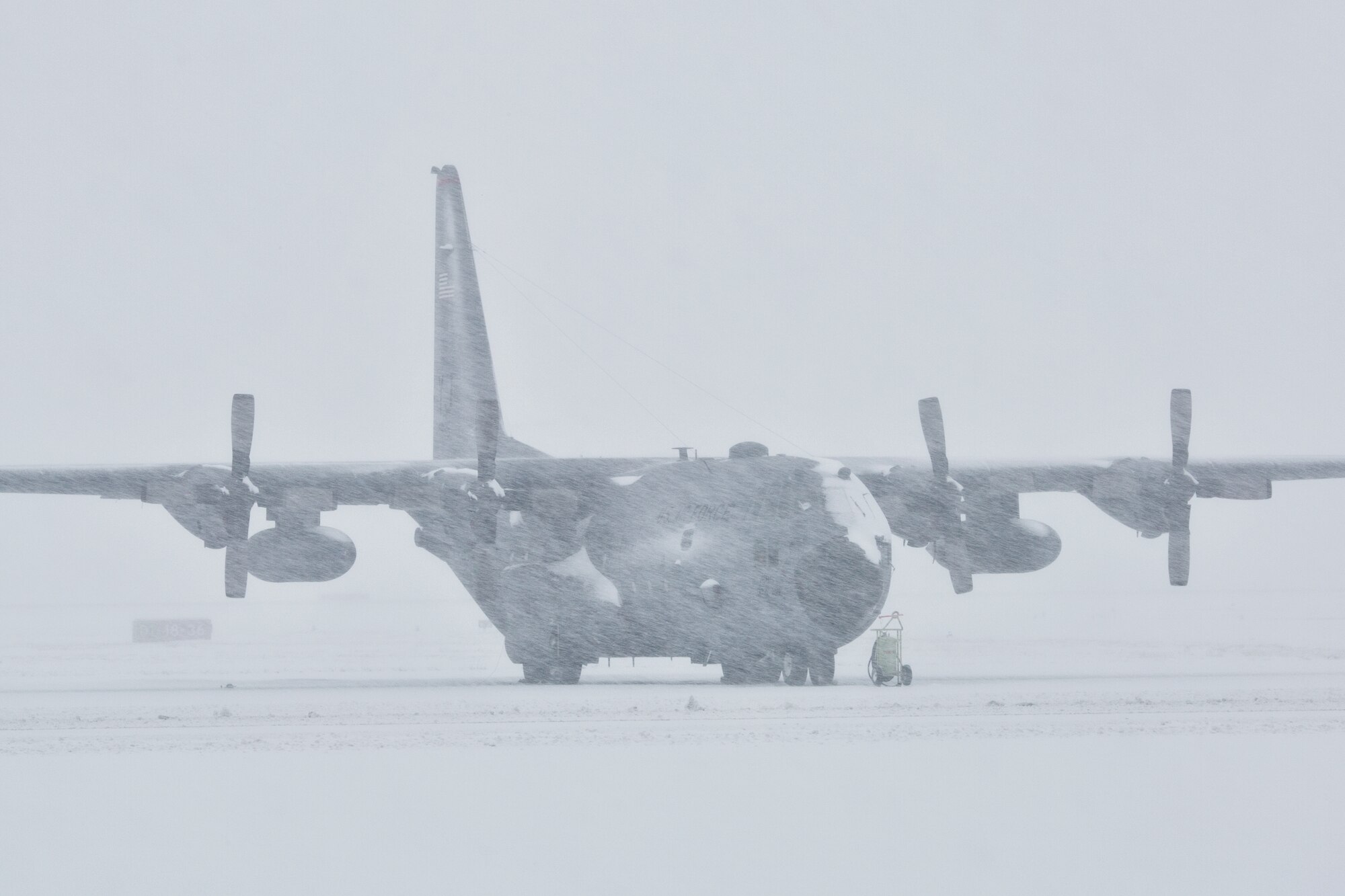 A snow-covered C-130 Hercules sits on the flightline at Yokota Air Base, Japan during the strongest snowstorms, Feb. 8, 2014. 12.7 inches of snow fell on base Saturday, breaking the daily record for February. (U.S. Air Force photo by Osakabe Yasuo/Released)