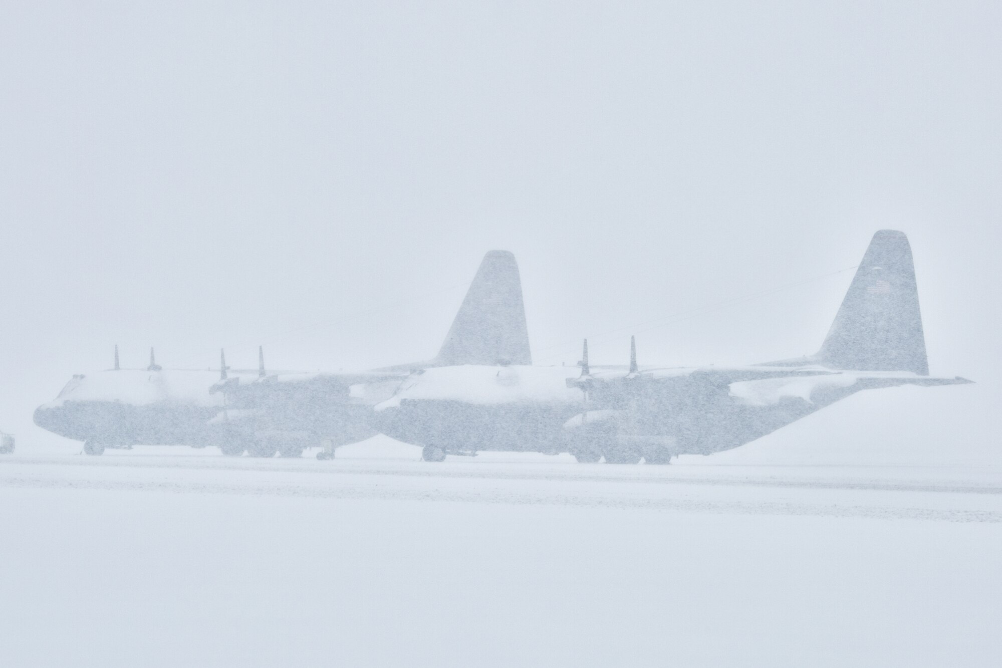 A snow-covered C-130 Hercules sits on the flightline at Yokota Air Base, Japan during the strongest snowstorms, Feb. 8, 2014. 12.7 inches of snow fell on base Saturday, breaking the daily record for February. (U.S. Air Force photo by Osakabe Yasuo/Released)