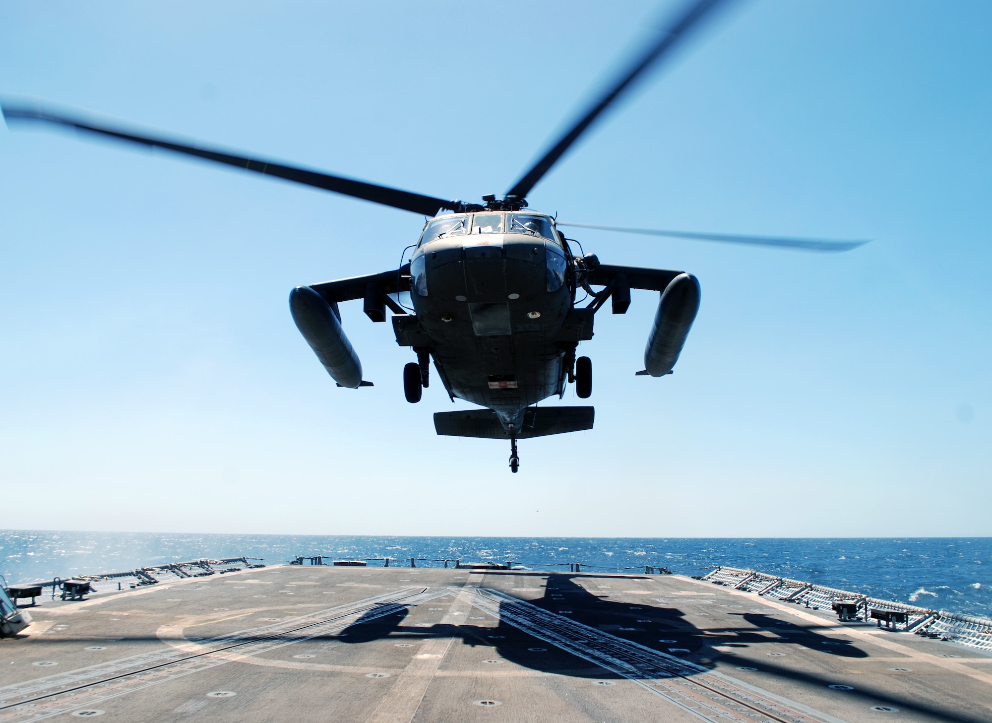 A UH-60 Blackhawk helicopter assigned to Joint Task Force Bravo's 1-228th Aviation Regiment comes in for a landing on the deck of the USS Rentz during deck landing qualification training off the coast of Honduras, Feb. 8, 2014. The training, which was conducted approximately 70 miles off the coast of Honduras, was done to qualify 1-228th pilots and crew chiefs on shipboard operations. (Courtesy photo)