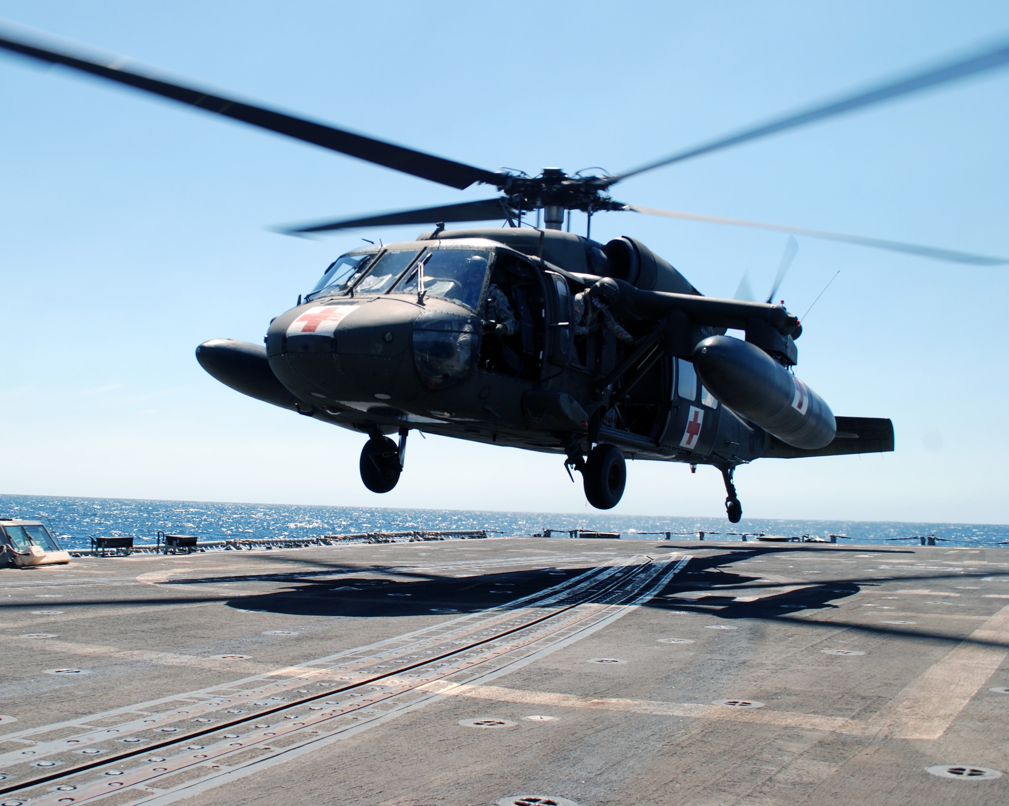 A UH-60 Blackhawk helicopter assigned to Joint Task Force Bravo's 1-228th Aviation Regiment comes in for a landing on the deck of the USS Rentz during deck landing qualification training off the coast of Honduras, Feb. 8, 2014. The training, which was conducted approximately 70 miles off the coast of Honduras, was done to qualify 1-228th pilots and crew chiefs on shipboard operations. (Courtesy photo)