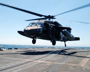 A UH-60 Blackhawk helicopter assigned to Joint Task Force Bravo's 1-228th Aviation Regiment comes in for a landing on the deck of the USS Rentz during deck landing qualification training off the coast of Honduras, Feb. 8, 2014. The training, which was conducted approximately 70 miles off the coast of Honduras, was done to qualify 1-228th pilots and crew chiefs on shipboard operations. (Courtesy photo)