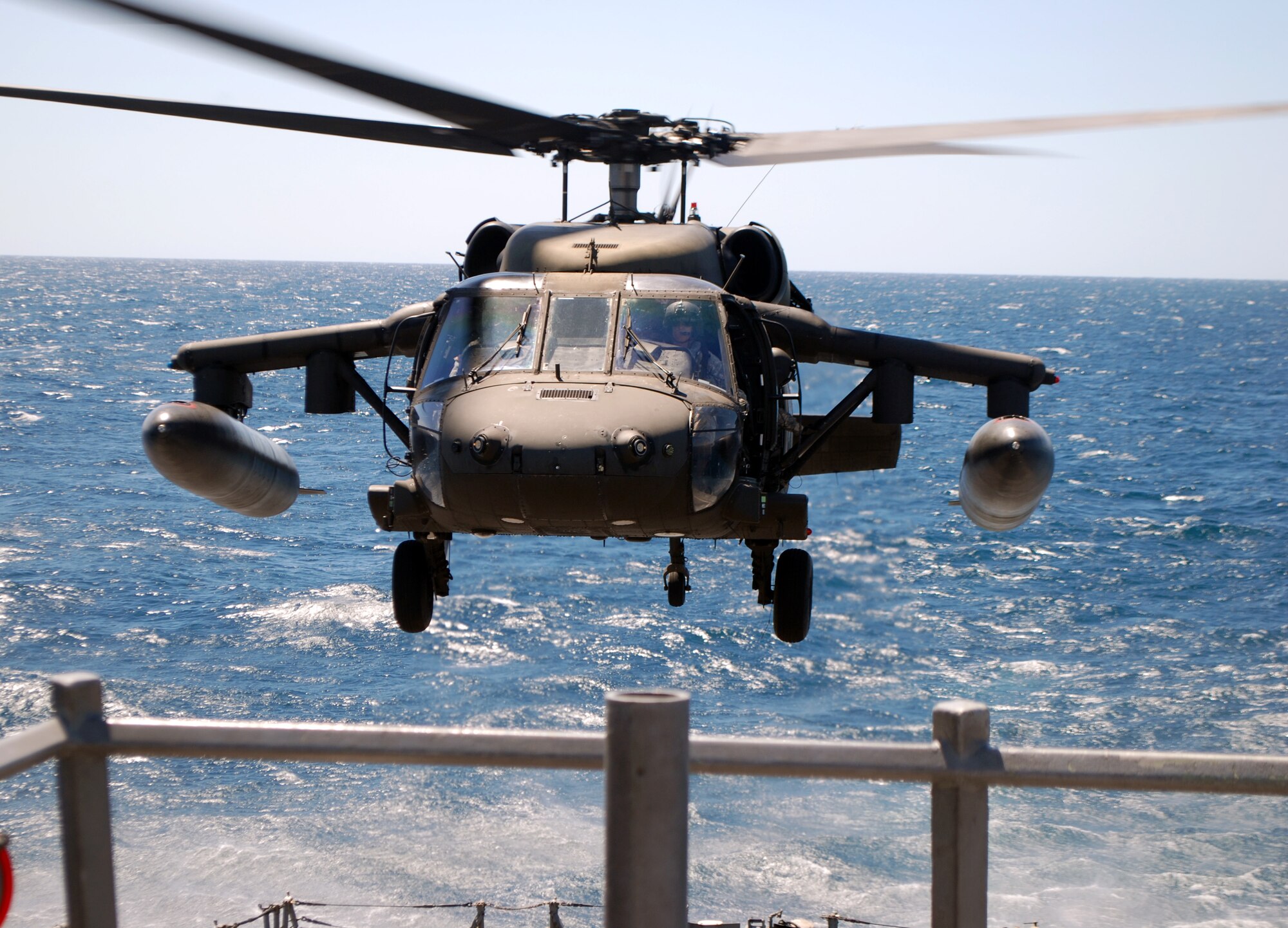 A UH-60 Blackhawk helicopter assigned to Joint Task Force Bravo's 1-228th Aviation Regiment makes an approach for a landing on the deck of the USS Rentz during deck landing qualification training off the coast of Honduras, Feb. 8, 2014. The training, which was conducted approximately 70 miles off the coast of Honduras, was done to qualify 1-228th pilots and crew chiefs on shipboard operations. (Courtesy photo)